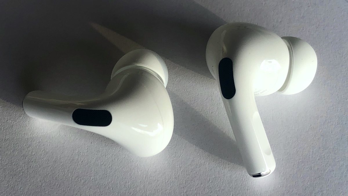 A pair of AirPods Pro with silicone ear tips, whose removable tips and tip mesh can clog and silence one side