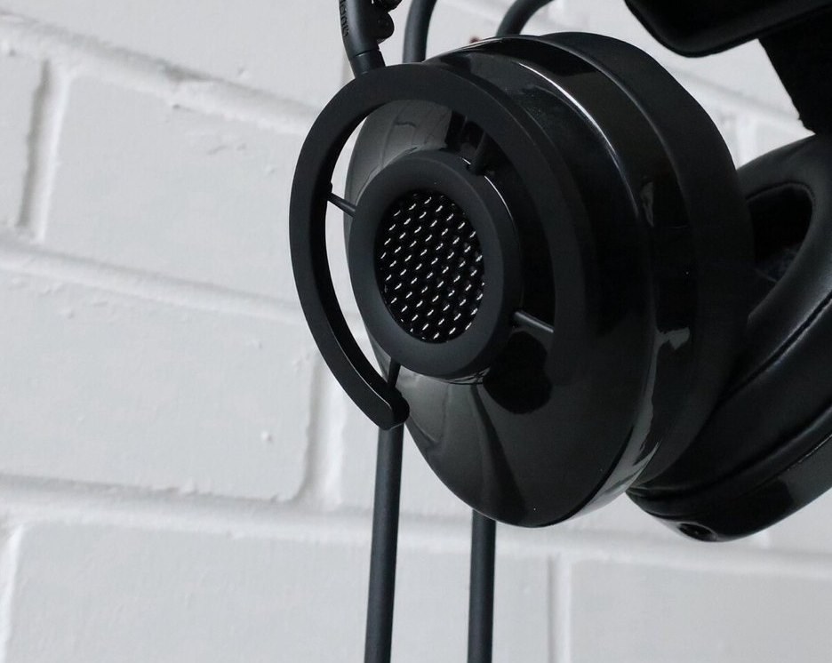 Close-up of an open-back over-ear headphone earcup and its perforated metal grille
