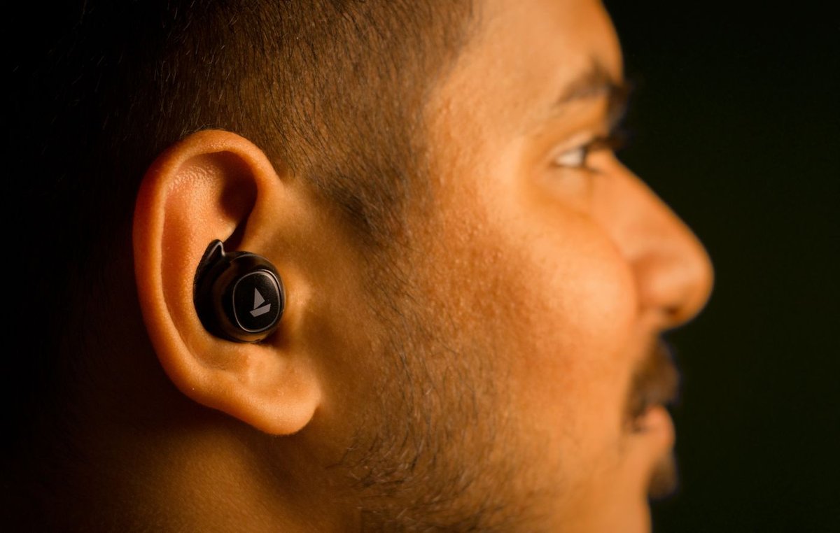 Close-up profile of a tipped in-ear earbud with its silicone tip seated inside the ear canal