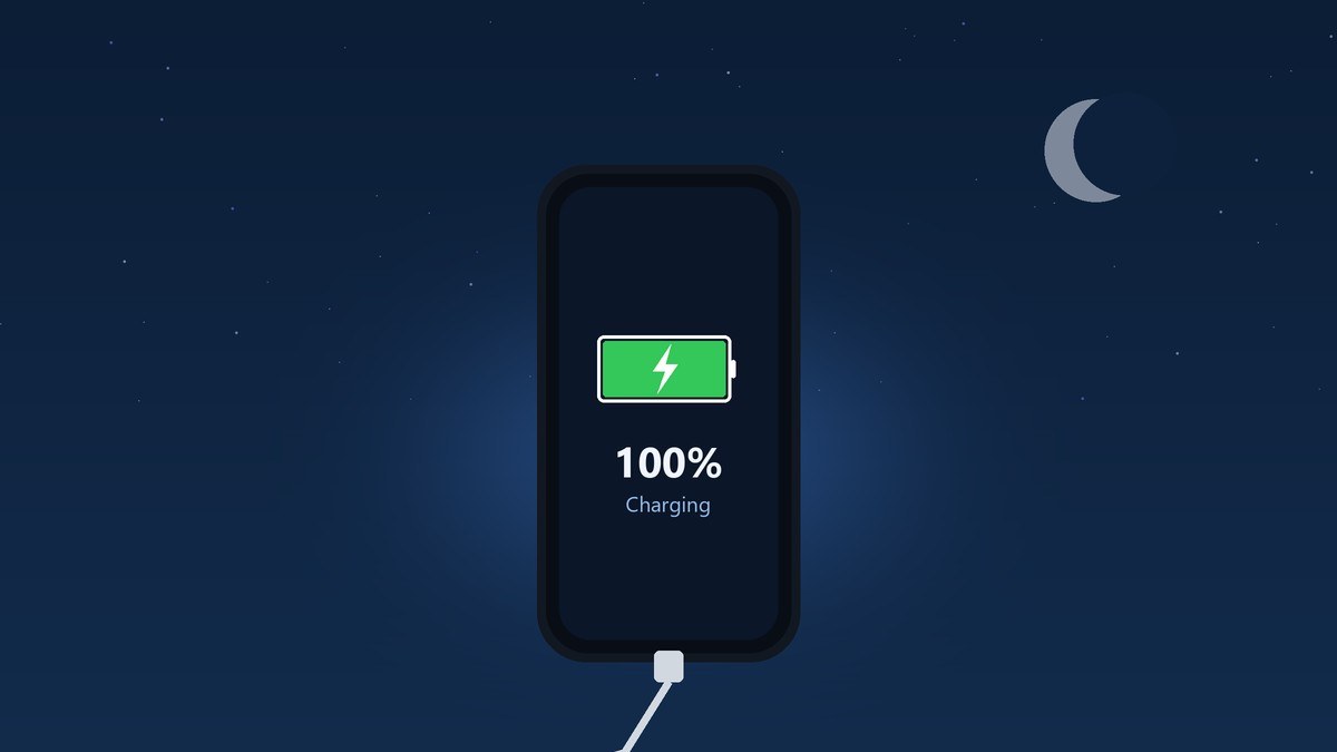 A smartphone on a nightstand at night showing a full battery and charging with a crescent moon in the sky