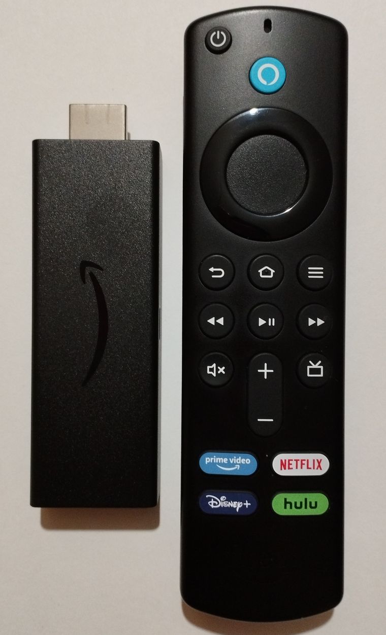 A Fire TV Stick next to a 3rd-generation Alexa Voice Remote that has a volume rocker, mute and power buttons near the base