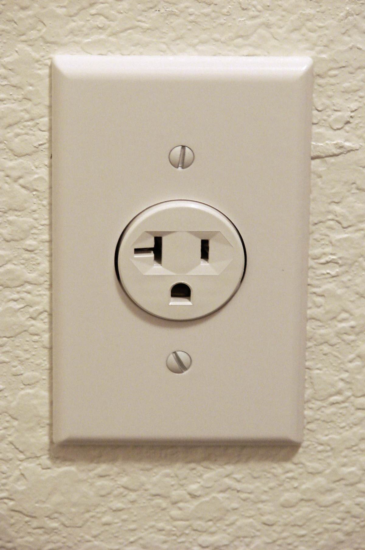 A standard North American wall power outlet mounted on a wall