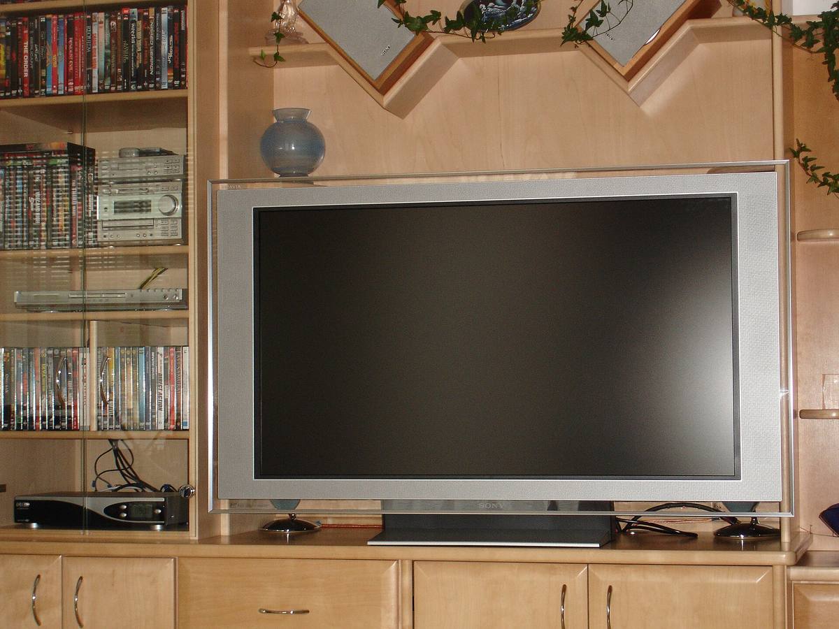 A flat-screen Sony BRAVIA LCD television sitting in a home entertainment cabinet with the screen switched off
